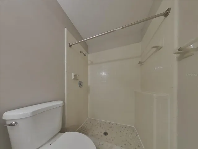 a bathroom with a shower and a toilet