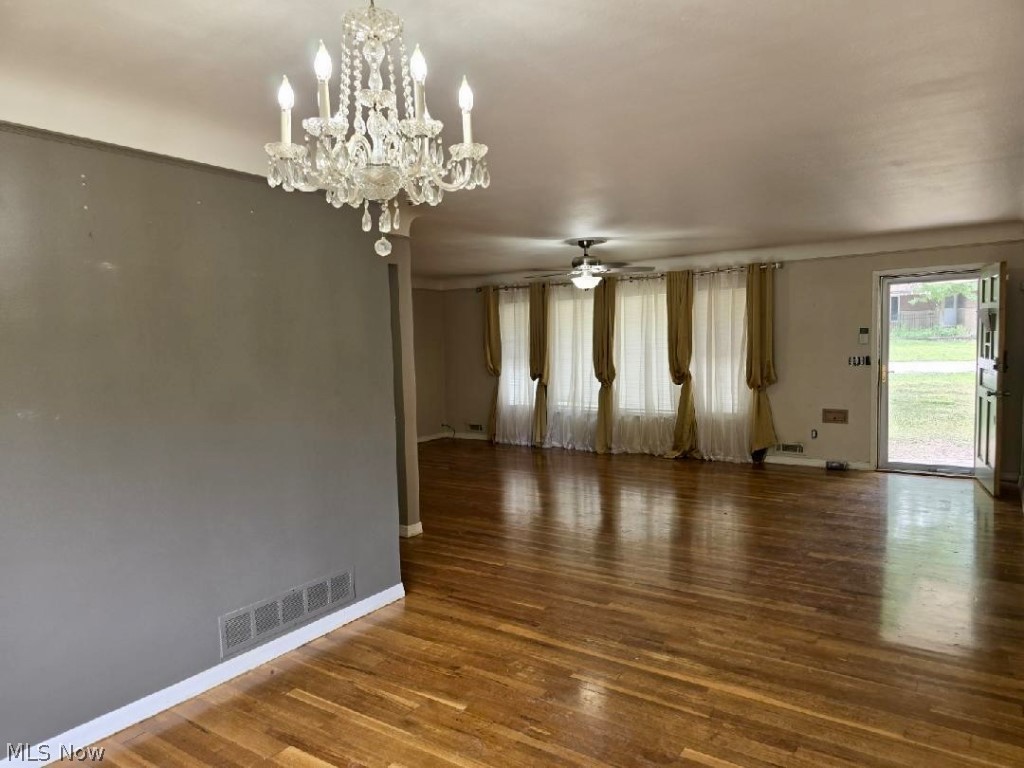 7735 Ragall Parkway Cleveland, OH 44130 - Photo 16 of 32 Spare room featuring dark hardwood / wood-style flooring and ceiling fan with notable chandelier