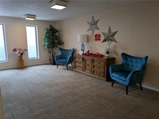 a bathroom with a granite countertop sink a mirror and shower