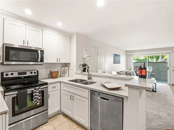 a kitchen with appliances a sink and cabinets