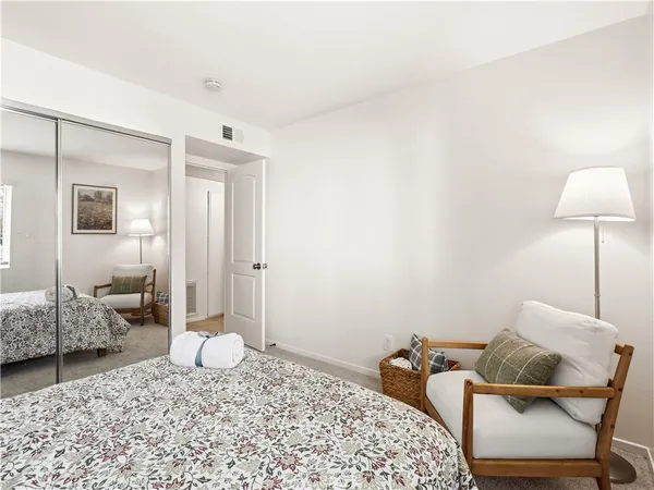 a bedroom with a bed and chair