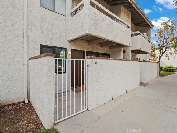 a view of a house with a small yard