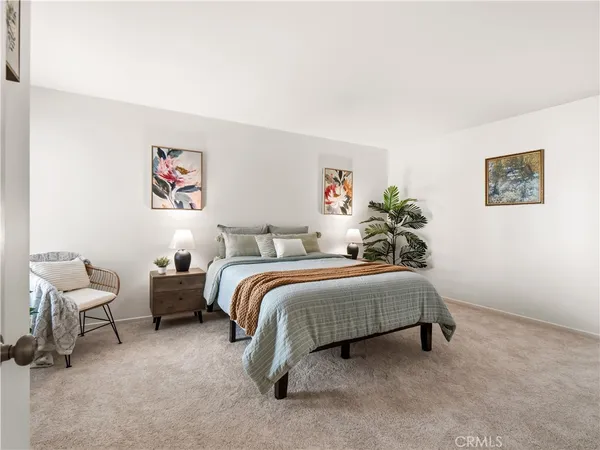 a spacious bedroom with a bed and furniture