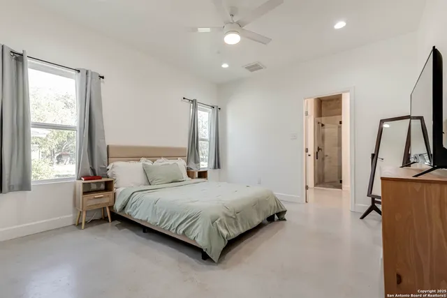 a bedroom with a bed and a flat screen tv