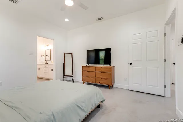 a bathroom with a double vanity sink mirror and shower