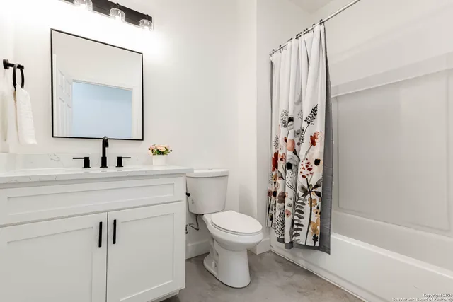 a living room with furniture a flat screen tv and a window