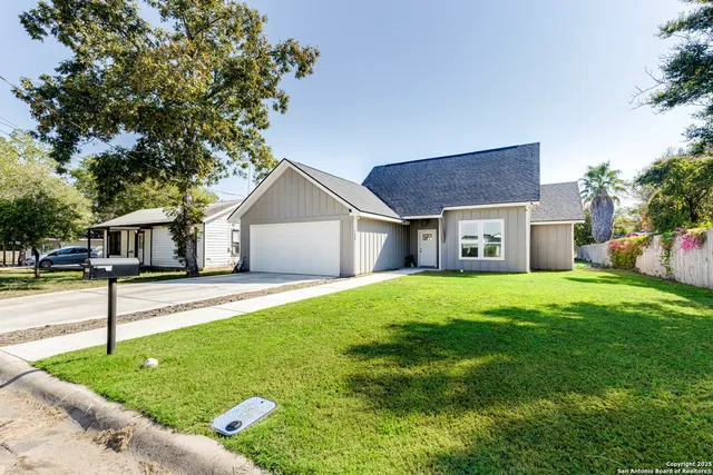a front view of house with yard and green space