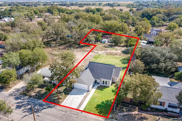 a view of a house with a yard and sitting area