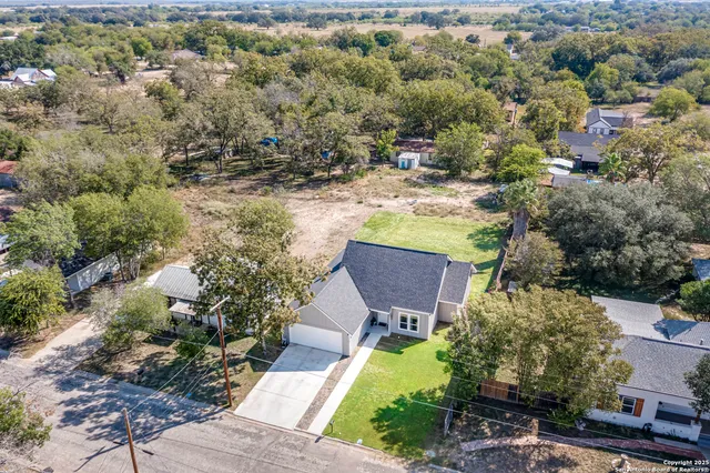 an aerial view of residential houses with outdoor space and swimming pool
