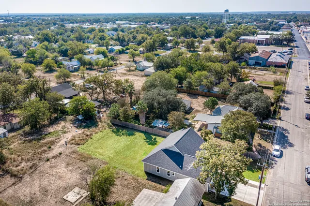 an aerial view of multiple houses with yard