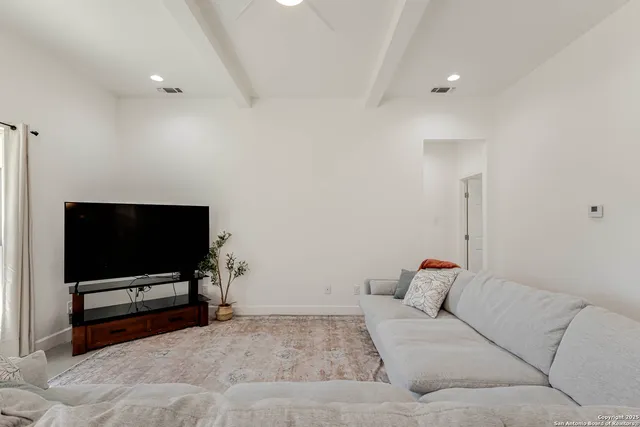 a living room with a flat screen tv and a couch
