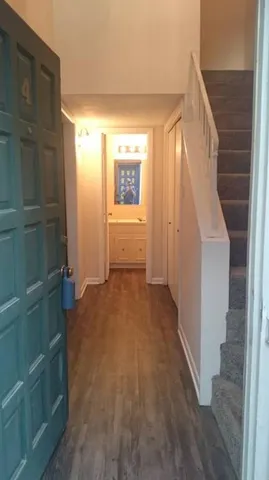 a view of a hallway with wooden shelves and entryway