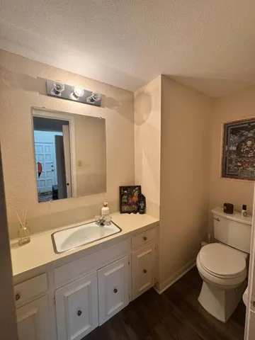 a bathroom with a toilet a sink and mirror