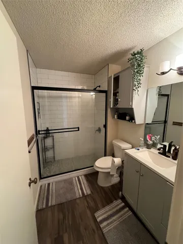 a bathroom with a sink toilet and shower