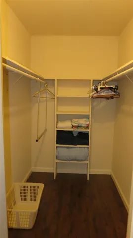 a view of walk in closet with empty racks