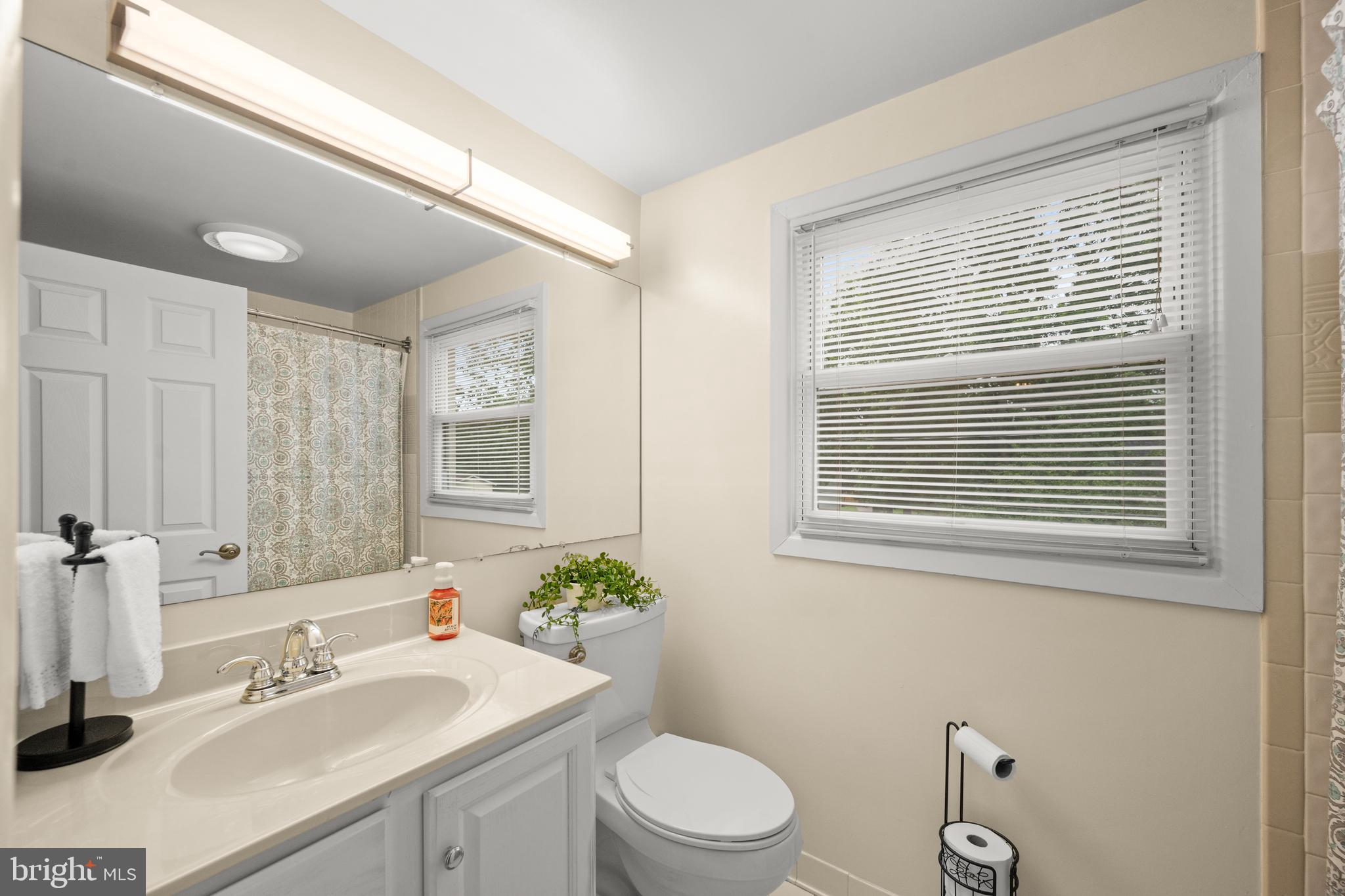 3402 Morlock Lane Bowie, MD 20715 - Photo 17 of 21 a bathroom with a sink a toilet and mirror
