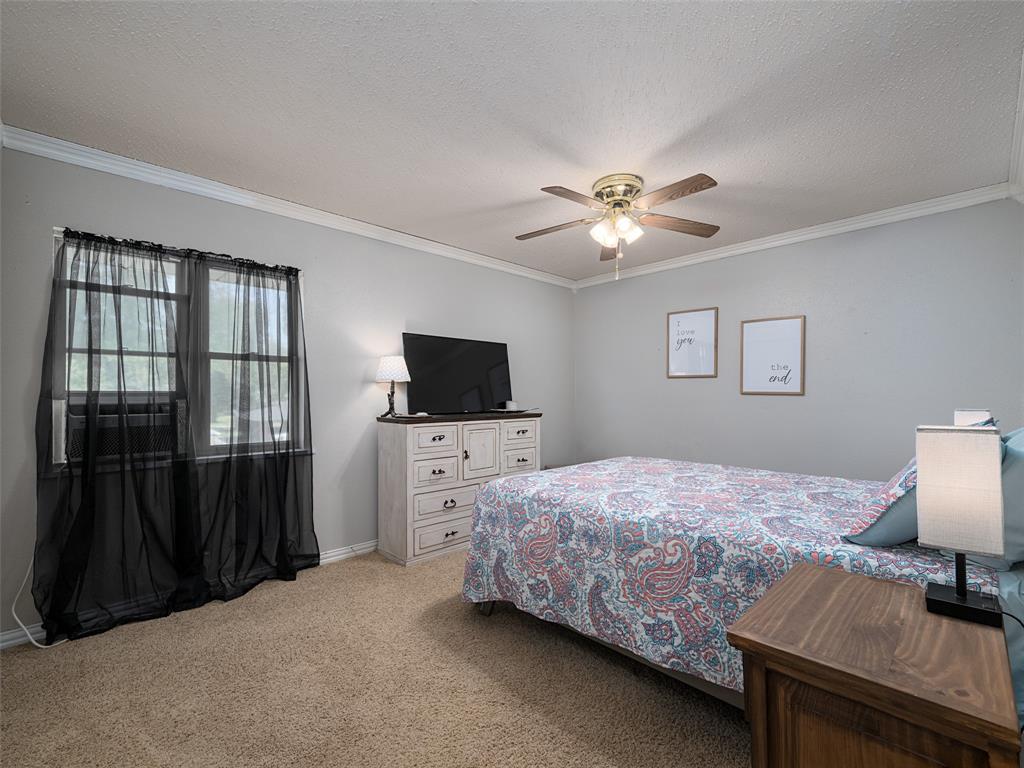 808 Walters Frankston, TX 75763 - Photo 15 of 32 a bedroom with a bed and a flat screen tv