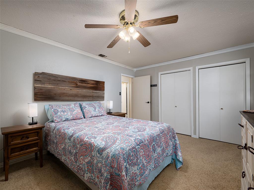 808 Walters Frankston, TX 75763 - Photo 16 of 32 a bedroom with a bed and a ceiling fan