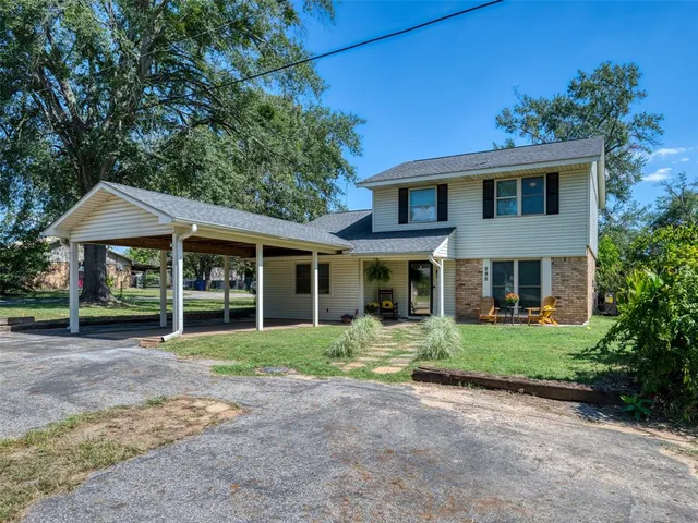 a front view of a house with a garden