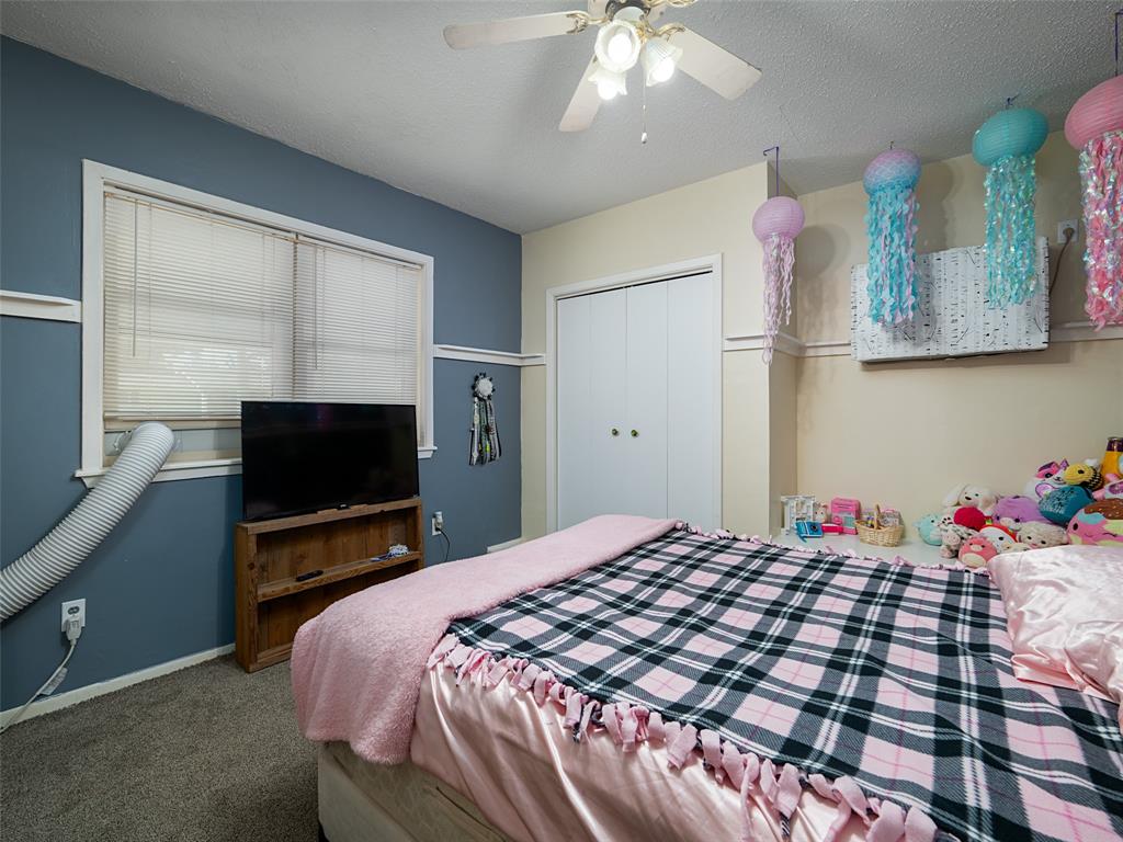 808 Walters Frankston, TX 75763 - Photo 22 of 32 a bedroom with a bed and a flat screen tv