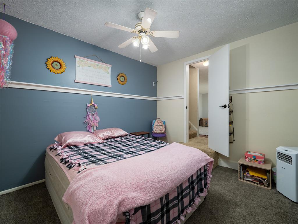 808 Walters Frankston, TX 75763 - Photo 23 of 32 a bedroom with a bed and a chandelier