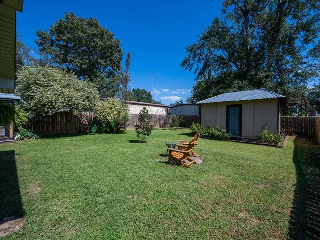 a view of a house with backyard porch and sitting area