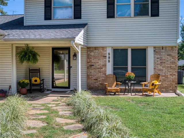 a view of a house with backyard porch and sitting area