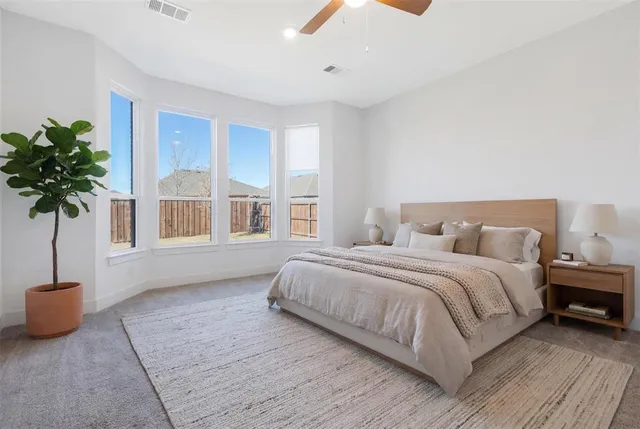 a spacious bedroom with a bed and a window