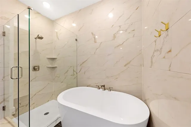 a bathroom with a bathtub and shower