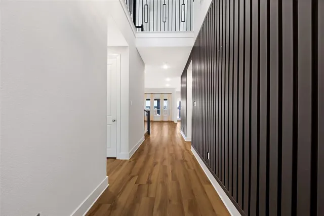 a view of a hallway with wooden floor