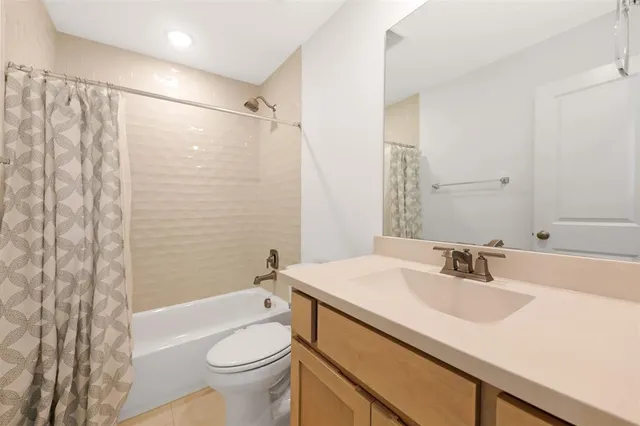 a bathroom with a sink a toilet and shower curtain