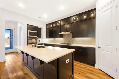 a kitchen with counter top space cabinets and stainless steel appliances