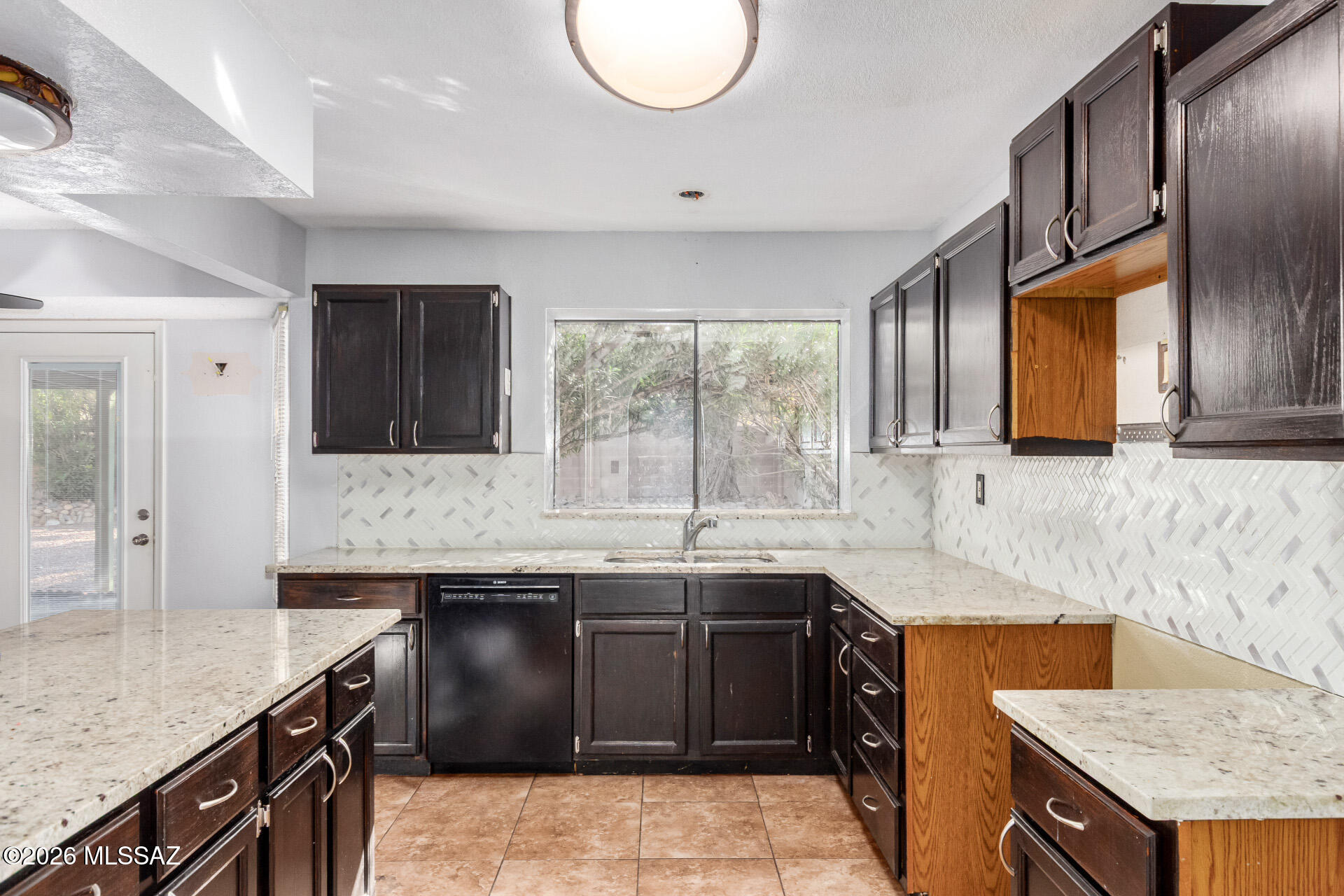 5331 West Eaglestone Loop Tucson, AZ 85742 - Photo 13 of 35 a kitchen with a sink stove and cabinets