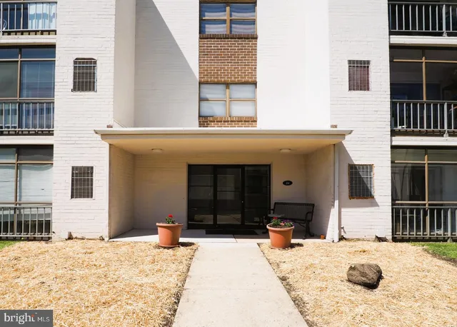 a front view of a house with barbeque grill and seating space
