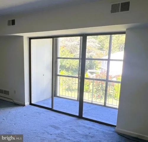 an empty room with a empty space and windows