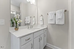 a bathroom with a double vanity sink and a mirror