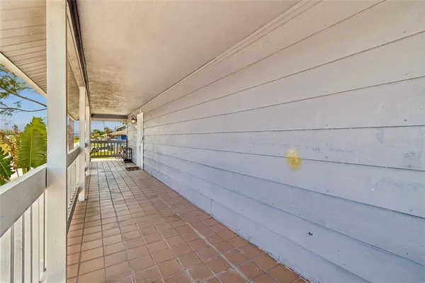 a spacious bathroom with a granite countertop sink and a washing machine