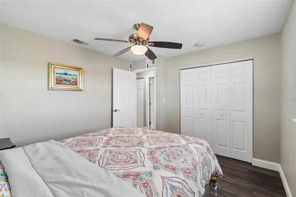 a bathroom with a granite countertop toilet sink and mirror