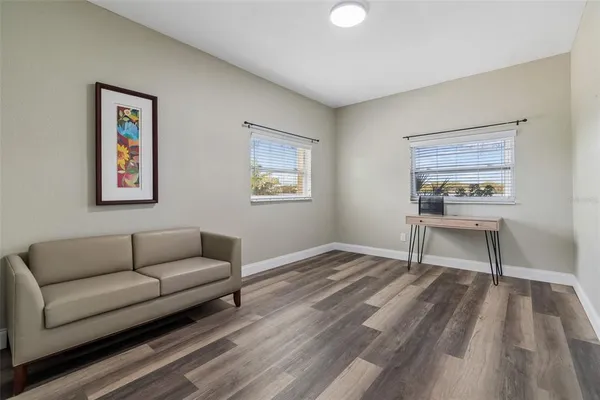 a living room with furniture and view of kitchen
