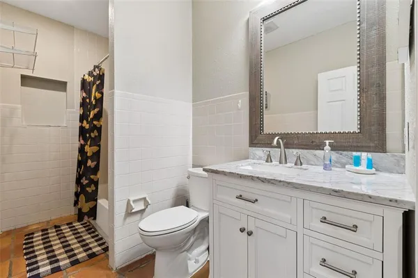 a view of a house with a small yard and wooden fence
