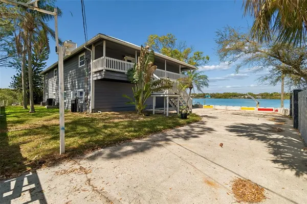 an aerial view of a house with swimming pool and lake view
