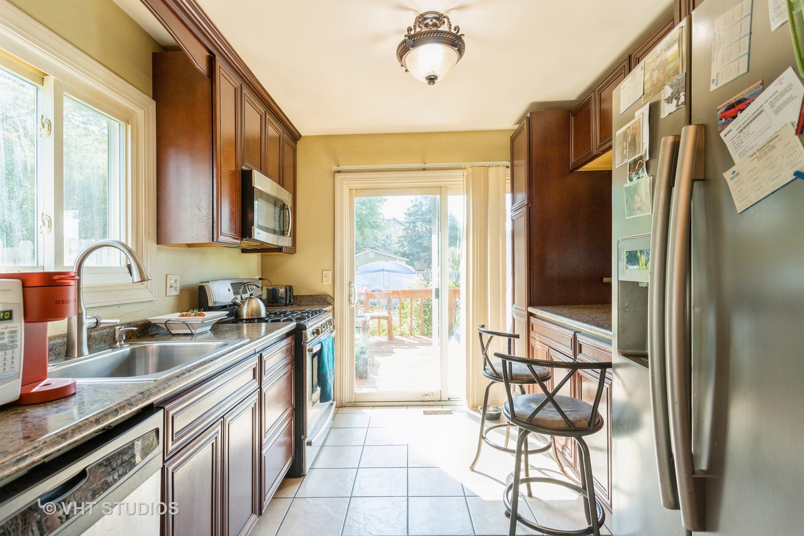 267 Westbrook Circle Naperville, IL 60565 - Photo 4 of 12 a kitchen with stainless steel appliances granite countertop a stove a sink and a refrigerator