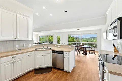 a kitchen with lots of counter top space and dining table