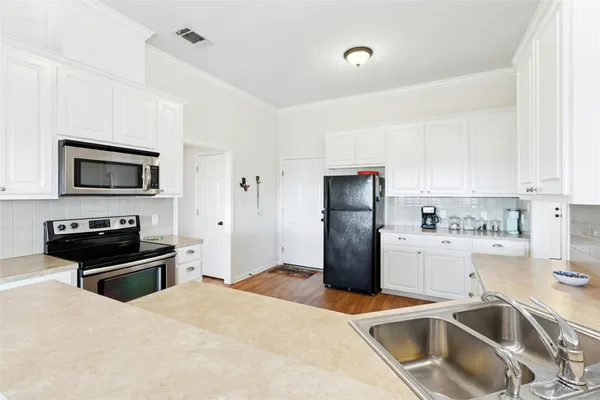 a kitchen that has a refrigerator and a sink