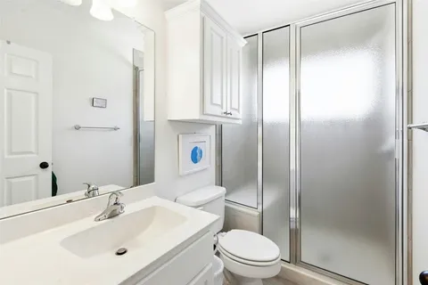 a bathroom with a sink toilet and shower