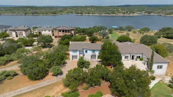 an aerial view of a house with a lake view