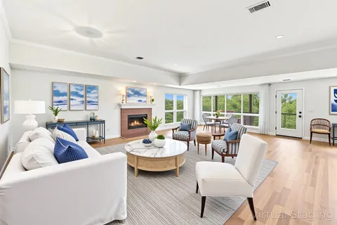 a living room with fireplace furniture and a wooden floor