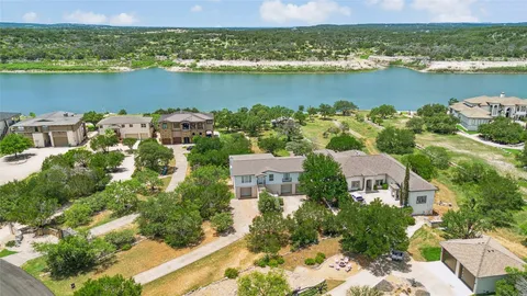 an aerial view of a houses with a lake view