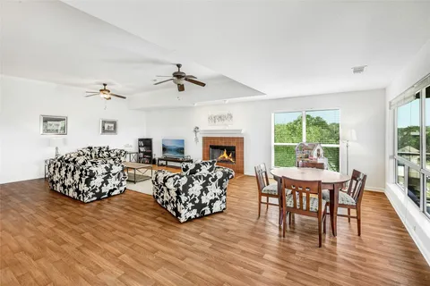 a living room with furniture fireplace and a large window