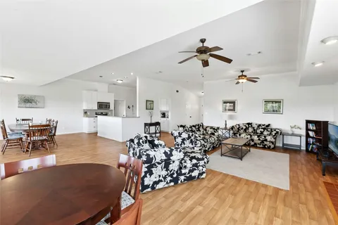 a living room with furniture or chandelier and a wooden floor